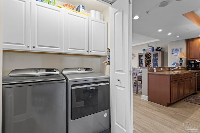 616 Lost Key Dr Unit 902A, Perdido Key, FL 32507 - washroom with cabinet space, washing machine and clothes dryer, light wood-style floors, recessed lighting, and crown molding