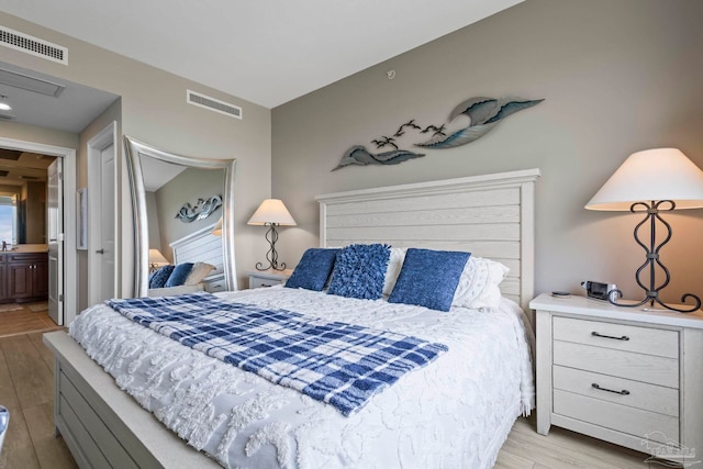 616 Lost Key Dr Unit 902A, Perdido Key, FL 32507 - bedroom featuring light wood-style flooring and ensuite bathroom