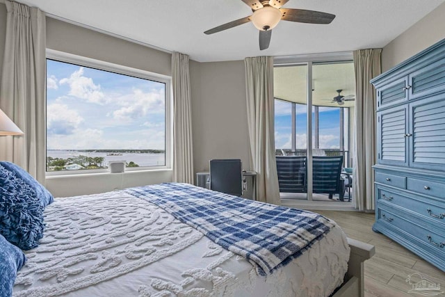 616 Lost Key Dr Unit 902A, Perdido Key, FL 32507 - bedroom with access to outside, multiple windows, light wood-style flooring, and a ceiling fan