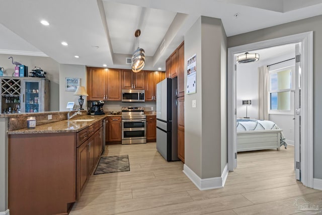 616 Lost Key Dr Unit 902A, Perdido Key, FL 32507 - kitchen featuring appliances with stainless steel finishes, a sink, light wood-type flooring, stone counters, and recessed lighting