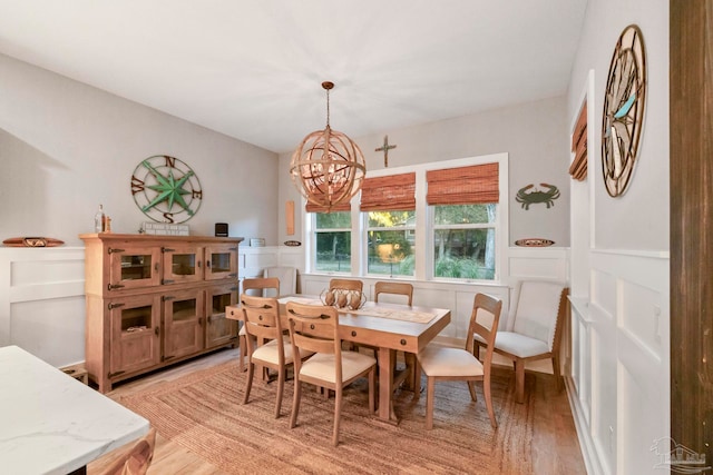 dining area featuring a chandelier and light hardwood / wood-style flooring