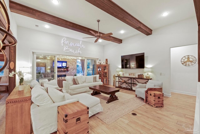 living room featuring ceiling fan, light hardwood / wood-style flooring, and beamed ceiling