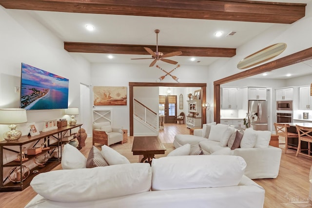 living room featuring beamed ceiling, french doors, light hardwood / wood-style flooring, and ceiling fan