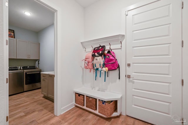 mudroom featuring separate washer and dryer and light hardwood / wood-style flooring