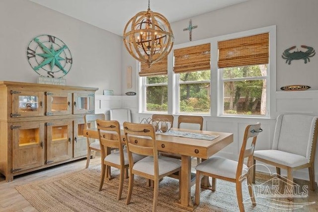 dining room featuring light hardwood / wood-style flooring and a chandelier