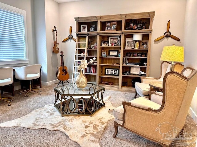 sitting room with carpet and ceiling fan