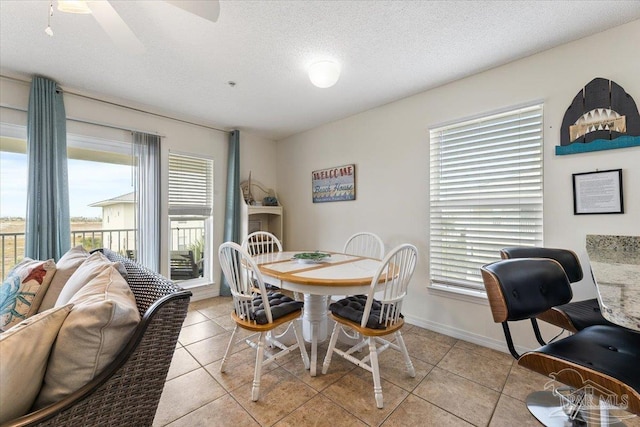 dining area featuring ceiling fan, plenty of natural light, and light tile patterned floors