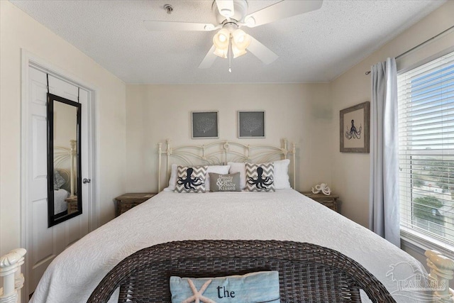 bedroom featuring a textured ceiling and ceiling fan