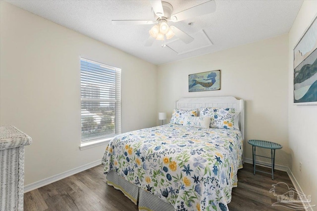 bedroom featuring dark hardwood / wood-style flooring, a textured ceiling, and ceiling fan