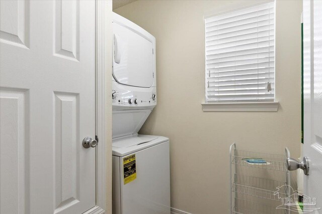 washroom with stacked washer and dryer