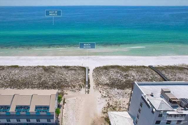 drone / aerial view featuring a water view and a view of the beach