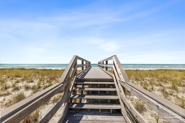 surrounding community featuring a view of the beach and a water view