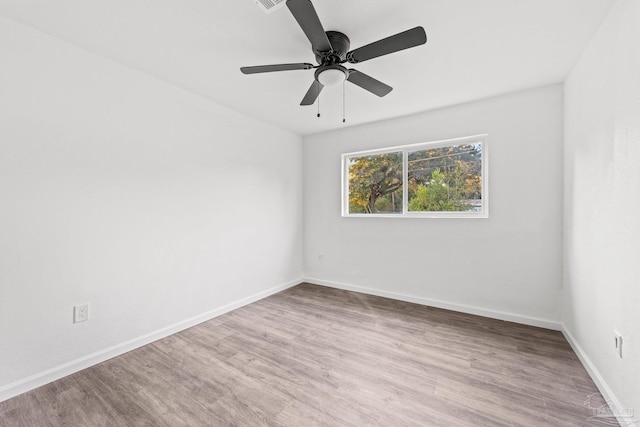 spare room with light hardwood / wood-style floors and ceiling fan