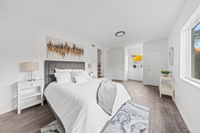 bedroom with dark hardwood / wood-style flooring