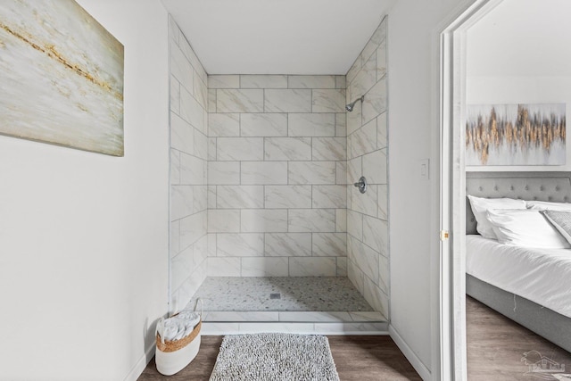 bathroom featuring wood-type flooring and tiled shower