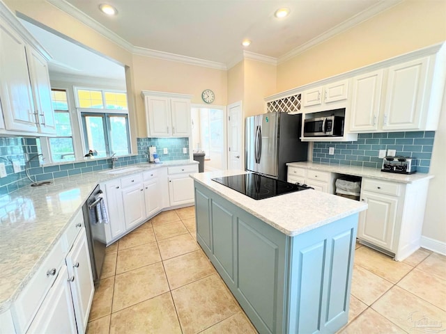 9351 Savane Park, Gulf Shores, AL 36542 - kitchen with appliances with stainless steel finishes, crown molding, white cabinetry, and a center island