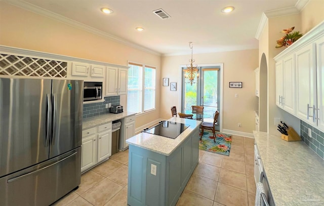 9351 Savane Park, Gulf Shores, AL 36542 - kitchen with appliances with stainless steel finishes, light tile patterned flooring, white cabinets, and a center island