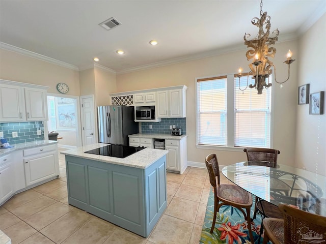 9351 Savane Park, Gulf Shores, AL 36542 - kitchen with appliances with stainless steel finishes, a kitchen island, pendant lighting, white cabinets, and a notable chandelier