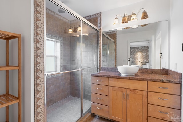 bathroom with vanity and a shower with door