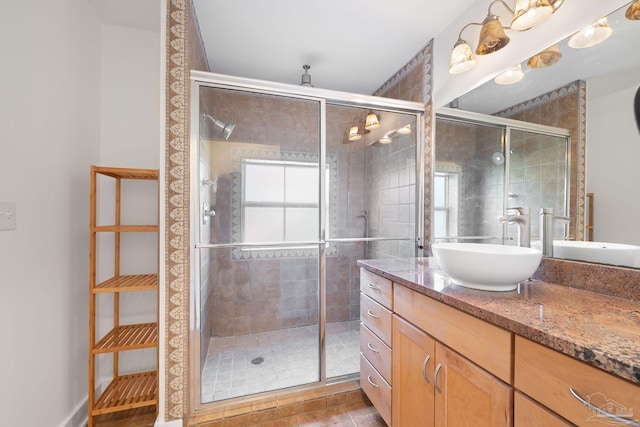 bathroom featuring tile patterned flooring, vanity, and a shower with shower door