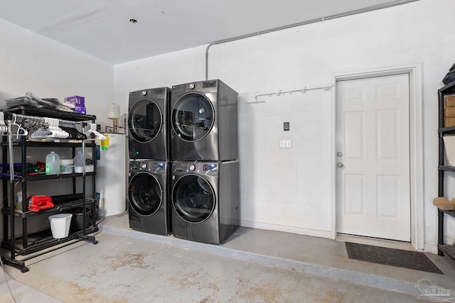 laundry area featuring stacked washing maching and dryer and water heater