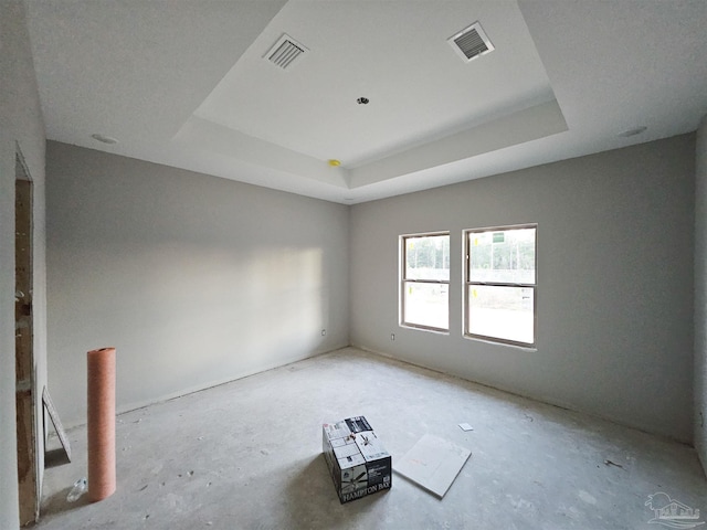 spare room featuring a tray ceiling