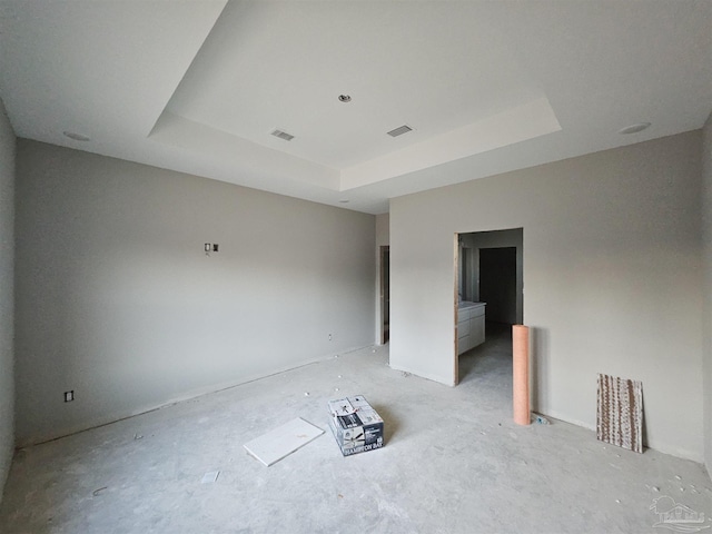 empty room featuring a tray ceiling