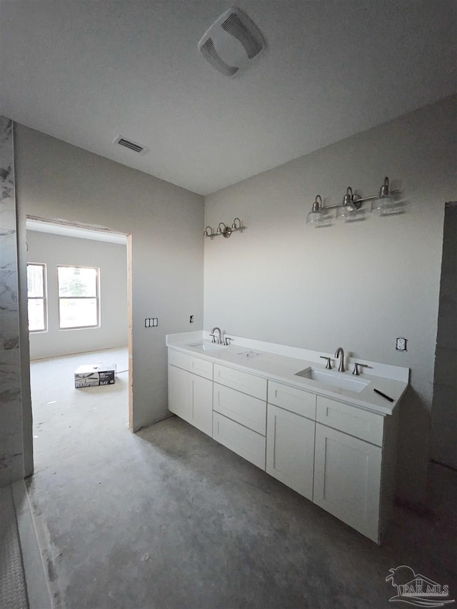 bathroom with vanity and concrete floors