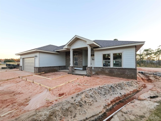 view of front facade featuring covered porch and a garage