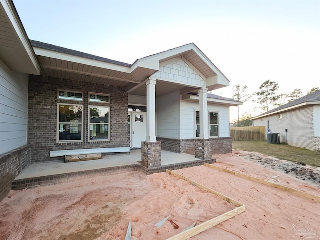 view of front facade featuring cooling unit and covered porch