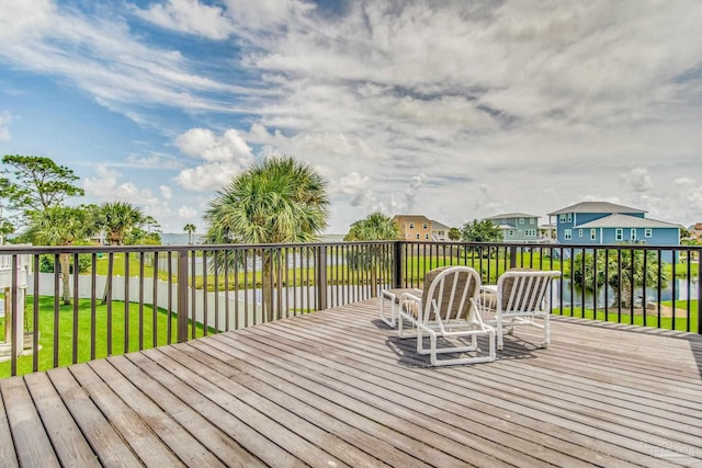 deck with a residential view and a lawn