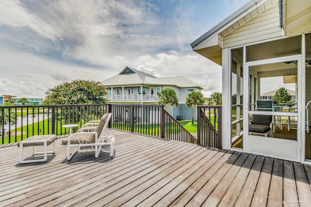 wooden terrace featuring a yard