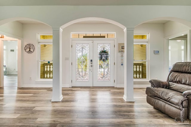 foyer entrance featuring wood finished floors and french doors