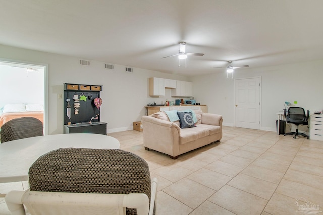 tiled living room with ceiling fan