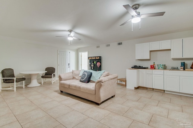 tiled living room with ceiling fan