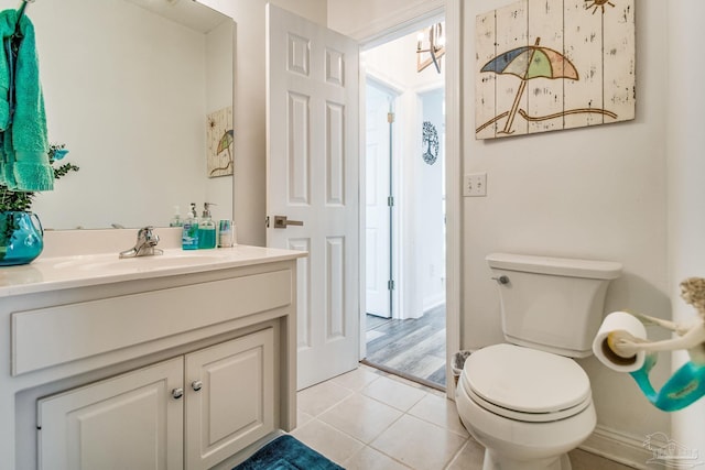 bathroom with vanity, toilet, and tile patterned floors