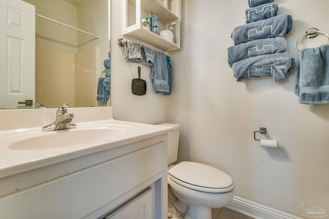 full bath with toilet, baseboards, walk in shower, and vanity