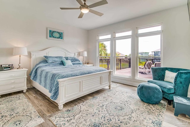 bedroom featuring access to exterior, light wood-type flooring, and ceiling fan