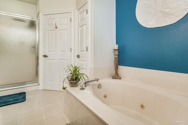 full bath with a jetted tub, a shower stall, and tile patterned floors