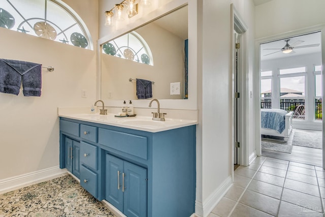 ensuite bathroom featuring double vanity, tile patterned floors, a sink, and ensuite bathroom