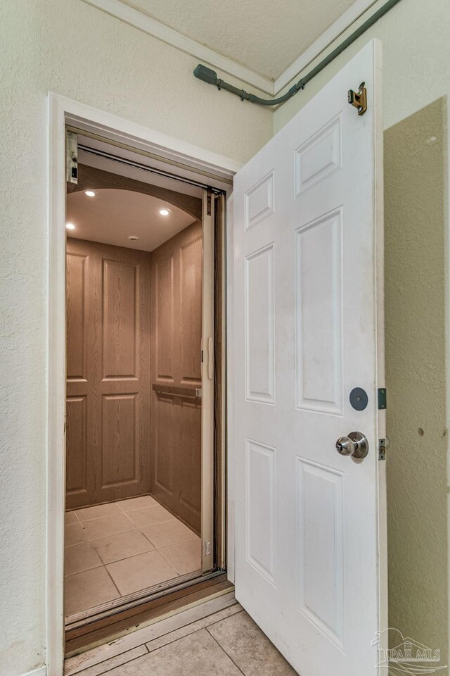 bathroom featuring vanity, toilet, an enclosed shower, and tile patterned floors