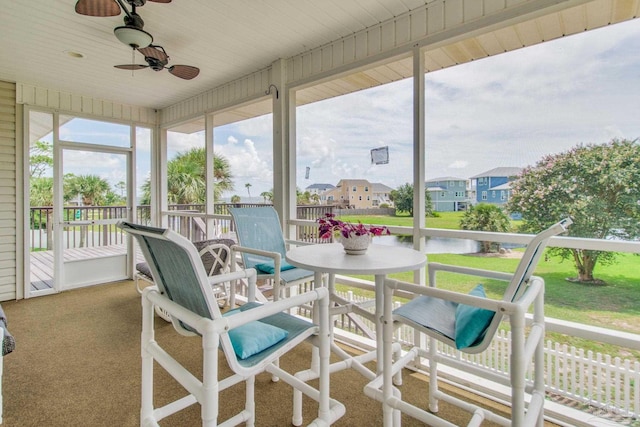 sunroom with ceiling fan and wooden ceiling