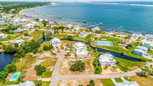 drone / aerial view with a residential view and a water view