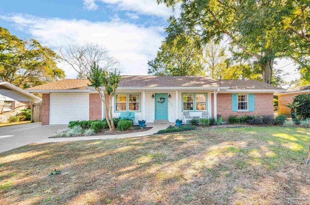 ranch-style home featuring a front lawn, covered porch, and a garage