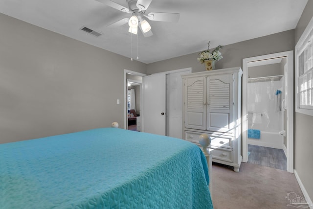 bedroom with carpet flooring, ceiling fan, and ensuite bath