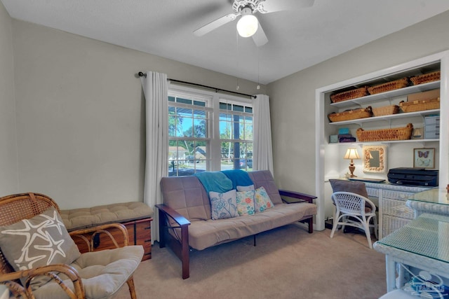 carpeted office featuring ceiling fan