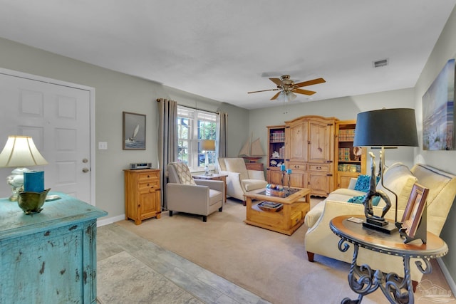 carpeted living room featuring ceiling fan