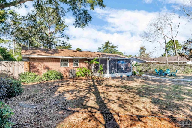 rear view of property with a sunroom