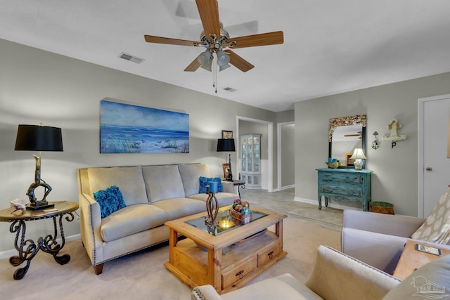 carpeted living room with ceiling fan