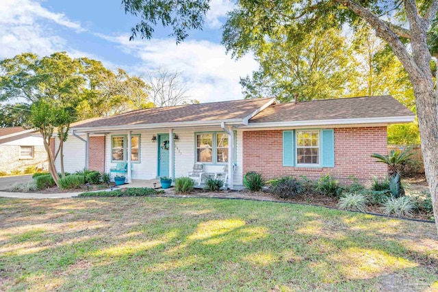 single story home with a porch and a front yard